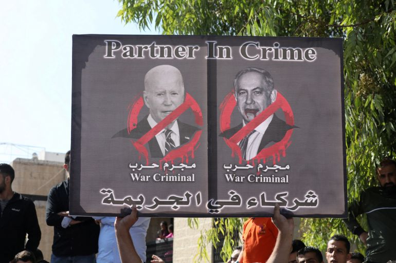 FILE PHOTO: A placard depicting U.S. President Joe Biden and Israeli Prime Minister Benjamin Netanyahu is held during a pro-Palestinian protest, after hundreds of Palestinians were killed in a blast at Al-Ahli hospital in Gaza that Israeli and Palestinian officials blamed on each other, in Amman, Jordan, October 18, 2023. REUTERS/Alaa Al Sukhni/File Photo
