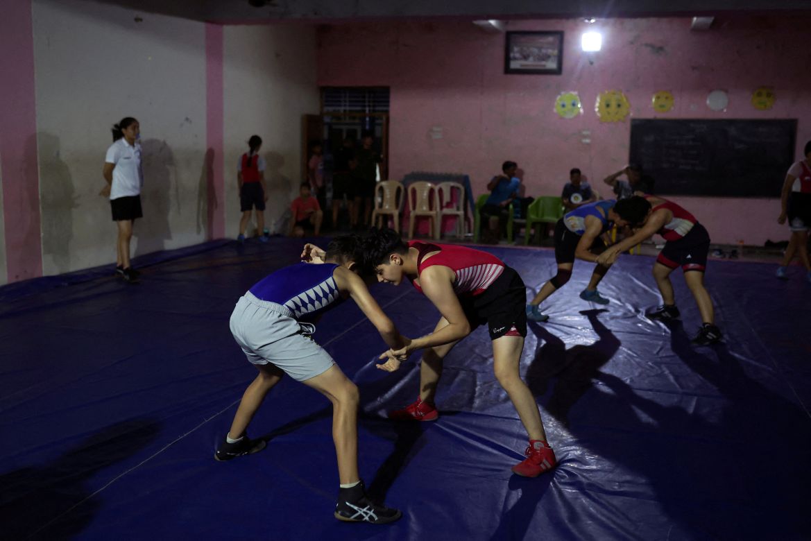 Students wrestle in bouts in the training room at the Altius wrestling school in Sisai, Haryana, India.