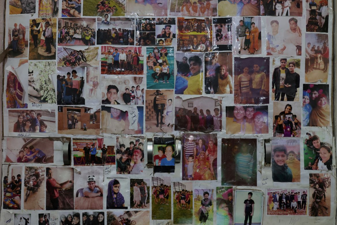 Pictures of the students and their loved ones hang on the wall next to their beds, at the Altius wrestling school's boarding hostel in Sisai, Haryana, India.