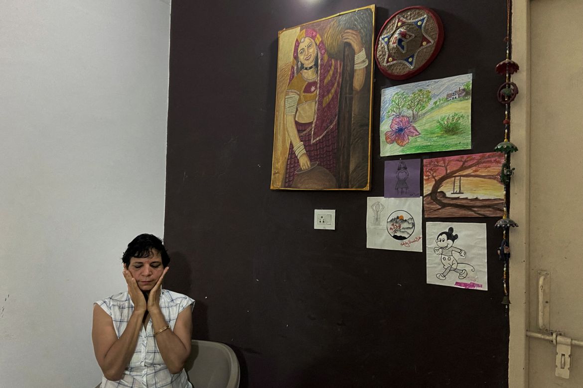 Usha Sharma, 50, who is an Assistant Sub-Inspector at Haryana's police department, reacts after an interview at home in Hisar, Haryana, India.