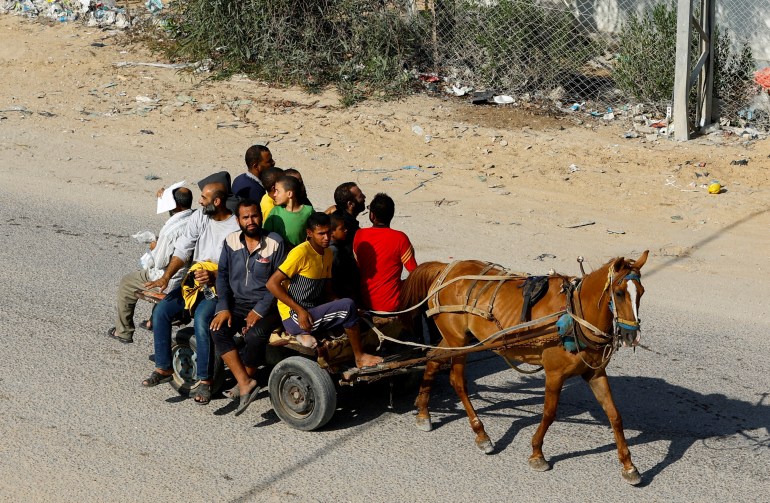 Palestinian workers who were in Israel during the Hamas October 7 attack, are transported on a horse-drawn cart