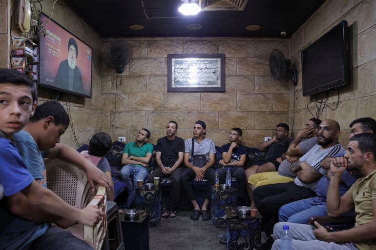 People watch Hezbollah's Secretary-General Hassan Nasrallah