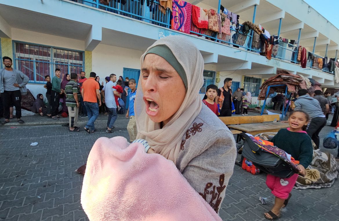 Palestinians react following a strike at a UN-run school sheltering displaced people, amid the ongoing conflict between Israel and Palestinian Islamist group Hamas, in the Jabalia refugee camp in the northern Gaza Strip