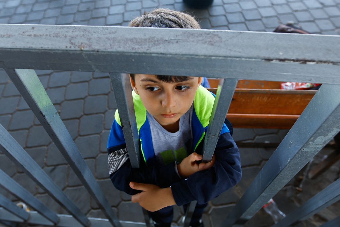 A boy stands as Palestinians with foreign passports wait for permission to leave Gaza