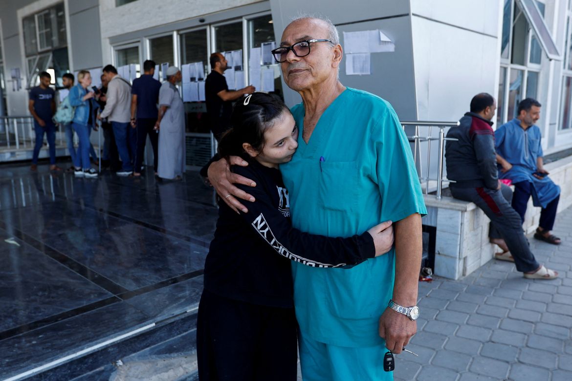 Palestinian doctor Mohammad Abu Namoos, who chose to stay in Gaza to treat patients, says goodbye to his daughter Dina before she leaves the strip, amid the ongoing conflict with Israel, at Rafah border crossing, in Rafah in the southern Gaza Strip