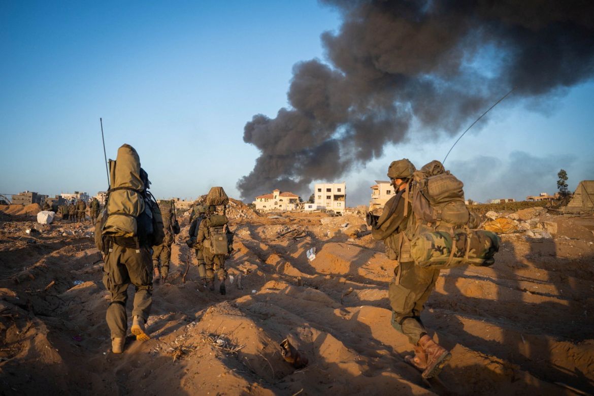 Israeli soldiers take position, amid the ongoing ground operation of the Israeli army against Hamas, in the Gaza Strip as seen in a handout picture released by the Israel Defense Forces.