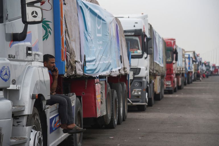 Trucks carrying humanitarian aid to Palestinians, wait on the desert road (Cairo - Ismailia) on their way to the Rafah border crossing to enter Gaza, amid the ongoing conflict between Israel and the Palestinian Islamist group Hamas, in Cairo