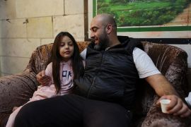 Palestinian Eyad Banat, who was detained by Israeli troops while doing a live broadcast on TikTok, talks to his daughter Sandi in his house in Hebron in the Israeli-occupied West Bank on November 13, 2023 [Mussa Qawasma/Reuters]