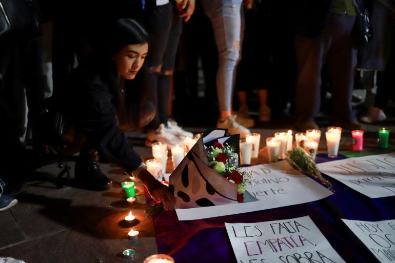 A person places flowers on the ground during a candlelight vigil and a protest after Mexico's first openly non-binary magistrate and LGBTQ activist, Ociel Baena, and their partner, Dorian Daniel Nieves Herrera, were found dead in their home, in Aguascalientes, Mexico. November 13, 2023. REUTERS/Edgar Chavez