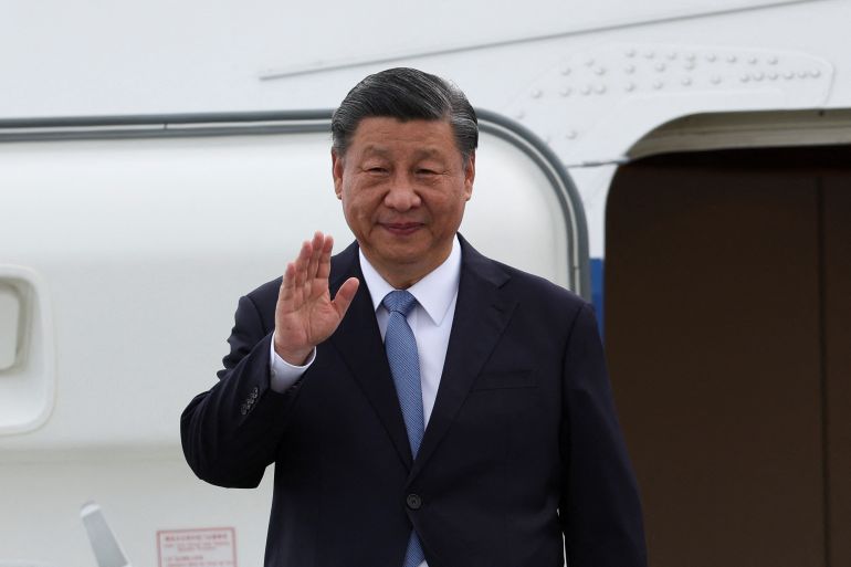 Xi waves from the plane after arriving in San Franciso.
