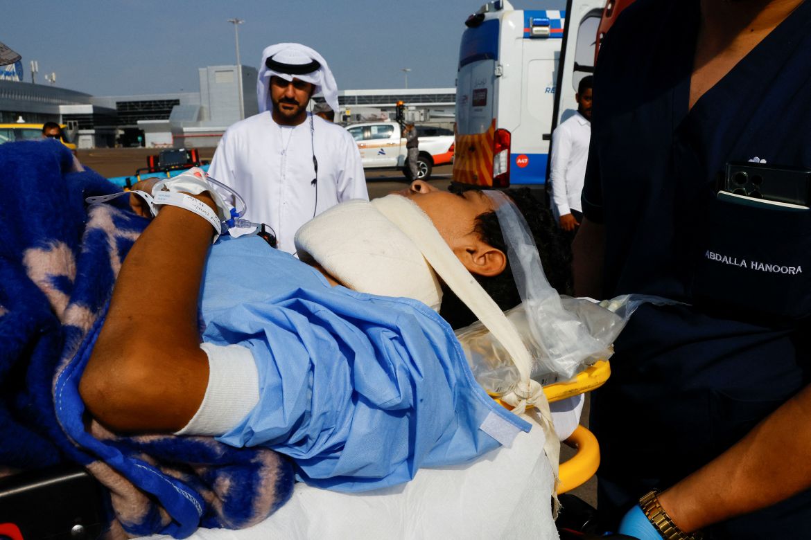A medic assists an injured child as Palestinian children and families who were evacuated from Gaza amid the ongoing conflict between Israel and Palestinian Islamist group Hamas, arrive to receive treatment in Abu Dhabi, United Arab Emirates