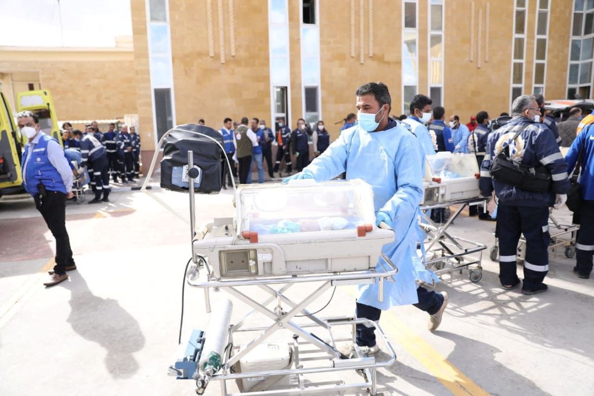 Medics transfer premature Palestinian babies evacuated from Gaza to ambulances on the Egyptian side of the Rafah border