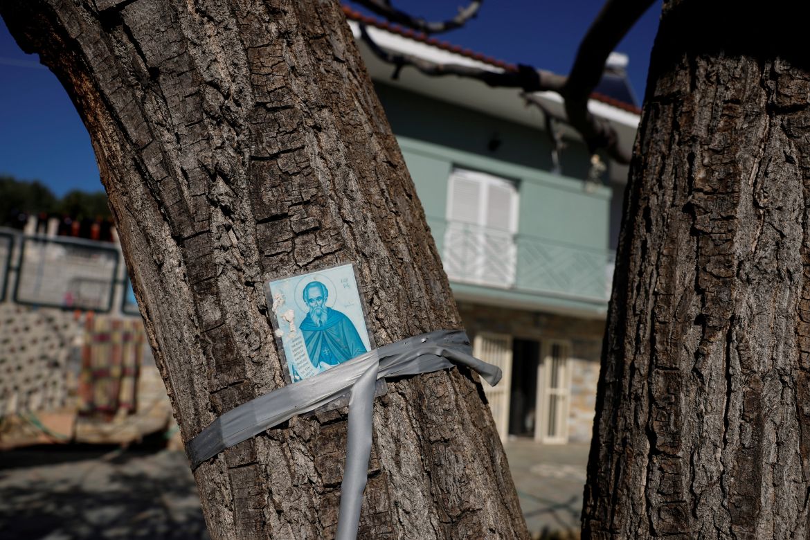 A holy icon is taped to a tree, in hopes of protection from disaster, in front of 46-year-old Vasilis Tsiamitas' house in the village of Sesklo, Greece.