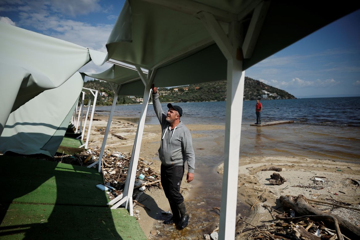 Vasilis Tsiamitas, 46, inspects damage at his beach bar in Chrissi Akti, also known as Golden Beach, near the village of Sesklo, Greece.