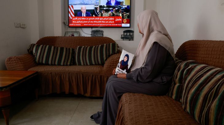 The mother of a female Palestinian prisoner, Shorouq Dwayyat watches her television for updates on the Israel-Hamas truce deal.