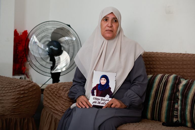 Sameera Dwayyat, the mother of Shorouq Dwayyat, 26, a female Palestinian prisoner serving a 16-year sentence, holds a picture of her daughter,