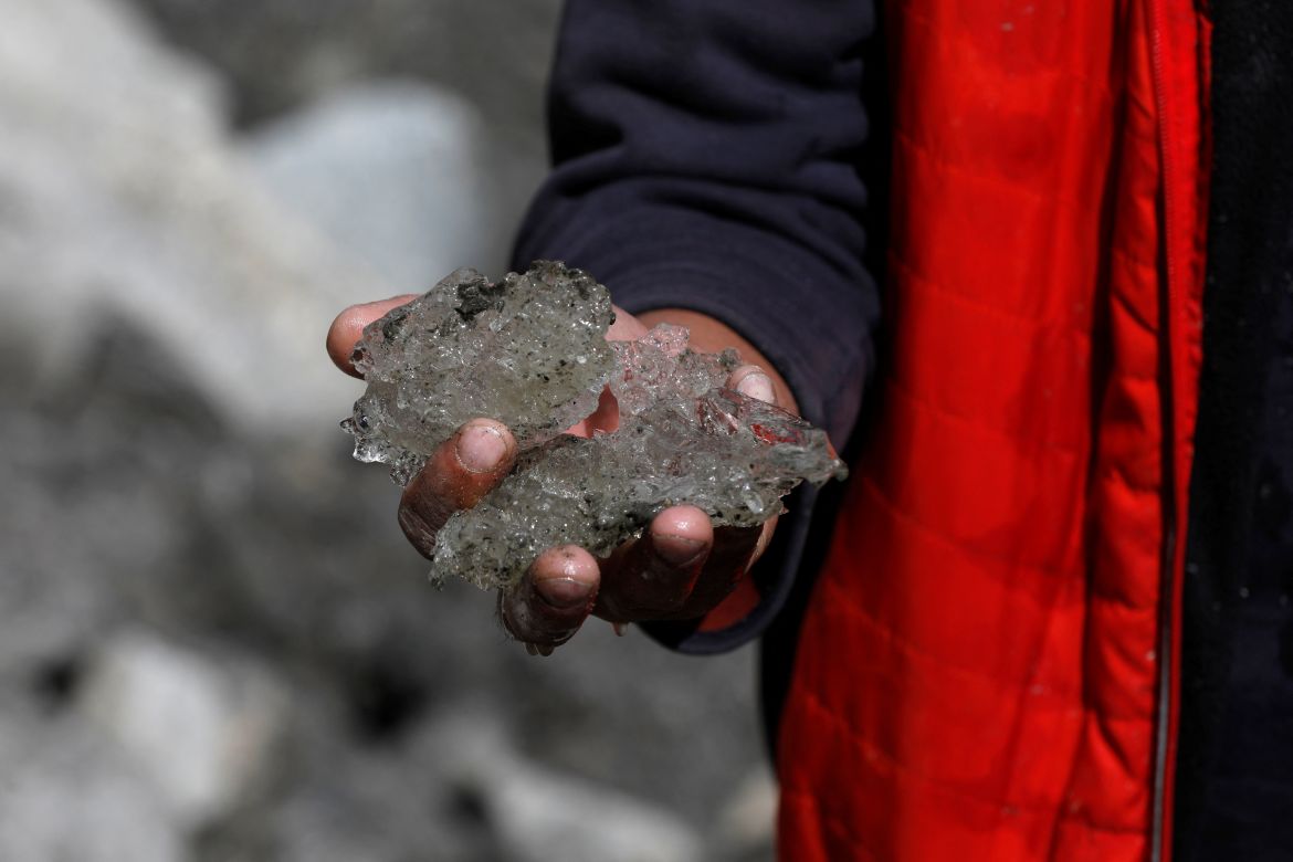 Tariq Jamil, 51, chairman of the Community Based Disaster Risk Management Centre, poses with ice taken from the Shisper glacier, near Hassanabad village, Hunza valley, in the Karakoram mountain range in the Gilgit-Baltistan region of Pakistan.