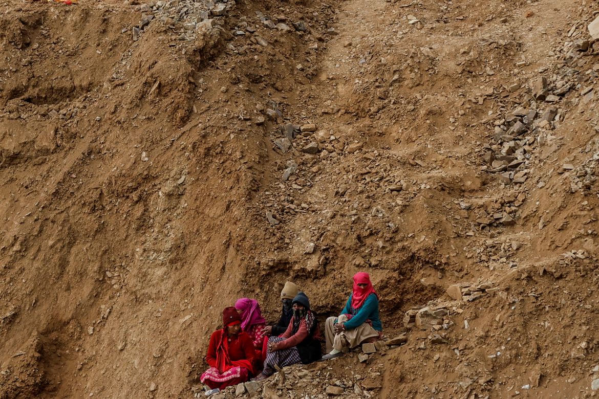 Women watch the rescue operations