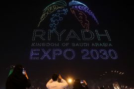 People watch fireworks and a light show in Riyadh on November 28, 2023, as Saudi Arabia celebrates winning its bid to host Expo 2030 [Ahmed Yosri/Reuters]