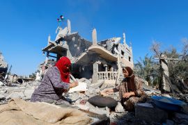 Palestinians bake bread near the ruins of houses destroyed in Israeli strikes [Mohammed Salem/Reuters]