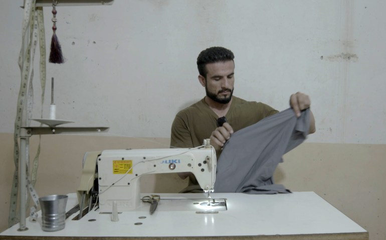 Asad at work in his tailoring worshop