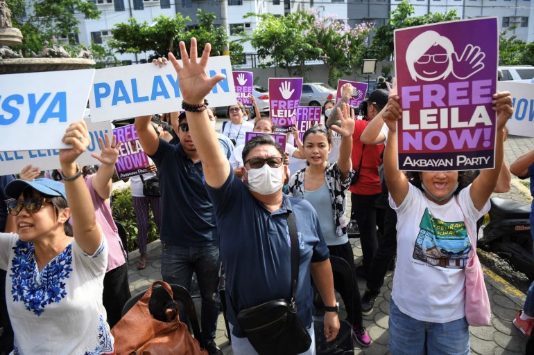 Supporters of former Philippine senator and human rights campaigner Leila de Lima protest outside a court after she was acquitted on one of two remaining drug trafficking charges in Muntinlupa city, suburban Manila