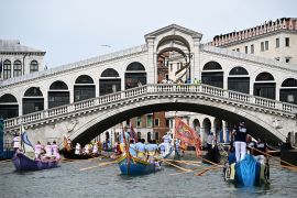 Travellers visit Venice to see sites including the Rialto Bridge and the Grand Canal [File: Gabriel Bouys/AFP]