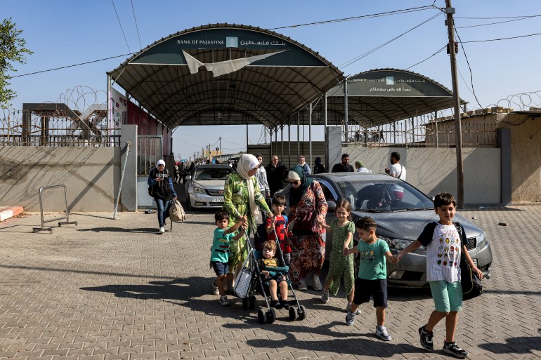 People enter the Rafah border crossing in the southern Gaza Strip before crossing into Egypt