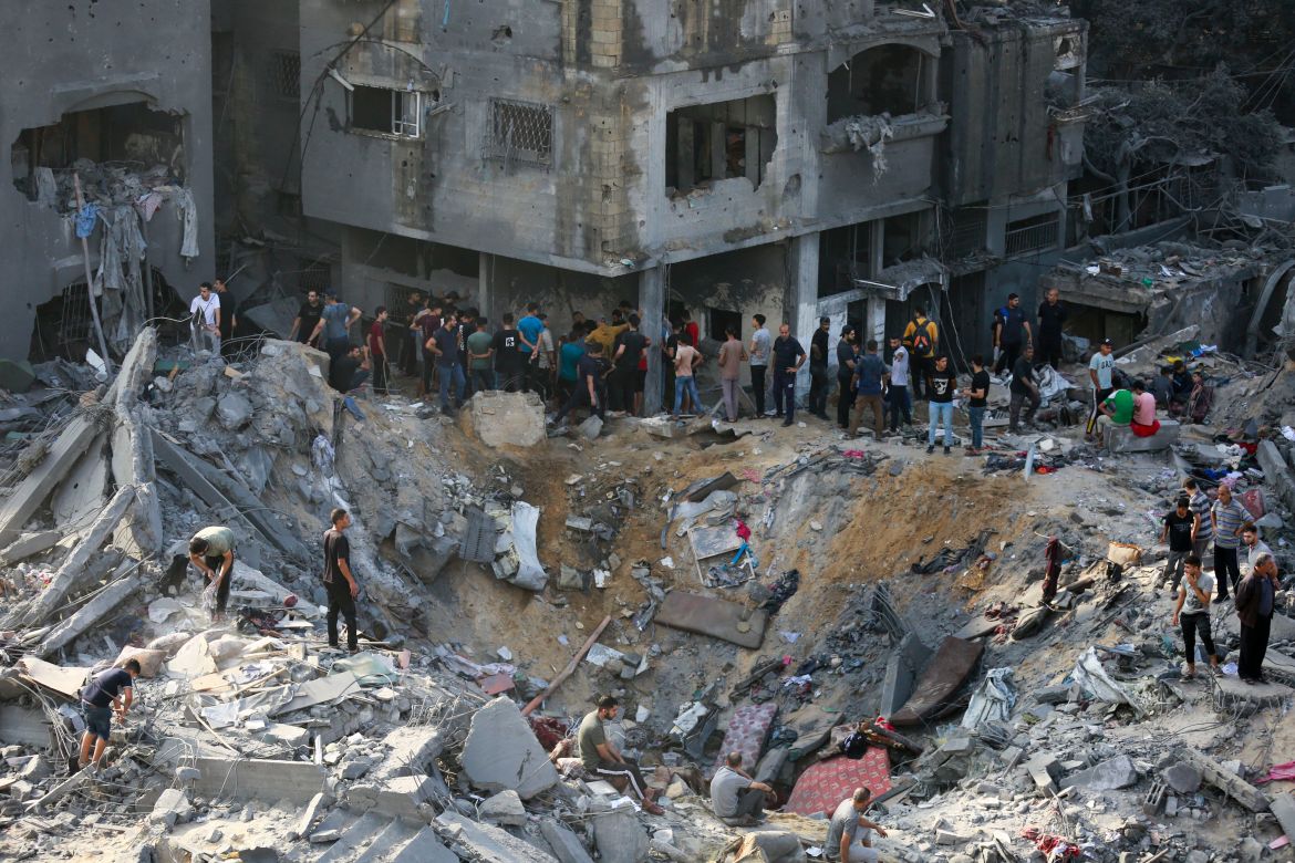 Palestinians check the destruction in the aftermath of an Israeli strike in the Jabalia camp for Palestinian refugees in the Gaza Strip,