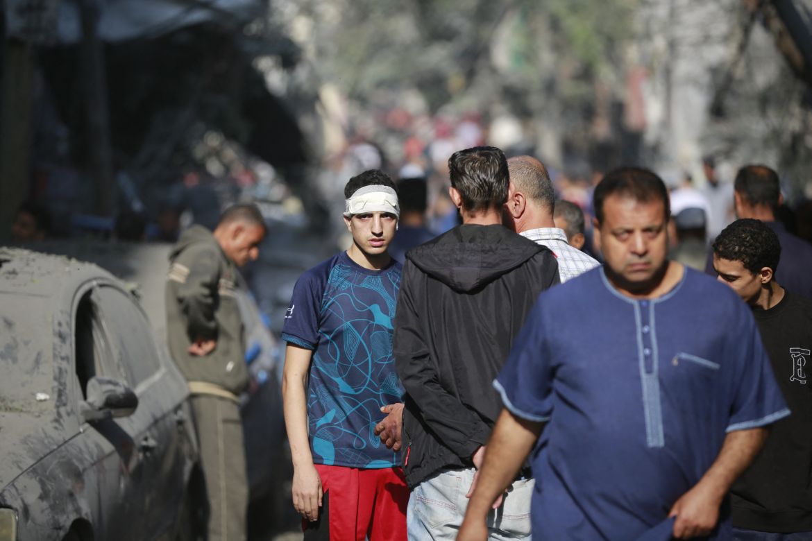 Palestinians walk in the aftermath of an Israeli strike in the Jabalia camp for Palestinian refugees in the Gaza Strip.