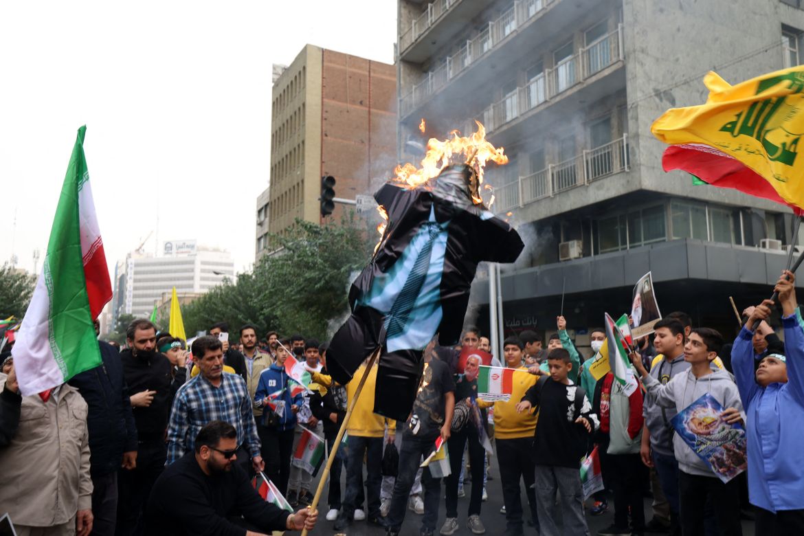 People burn an effigy of Israel's Prime Minister Benjamin Netanyahu during a rally outside the former US embassy in Tehran, to support the Palestinians of the Gaza Strip.