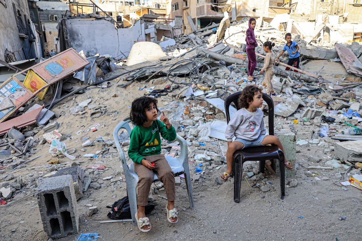 Palestinian children sit in front of the rubble of a destroyed building in Rafah in the southern Gaza Strip on November 6, 2023, amid the ongoing battles between Israel and the Palestinian group Hamas.