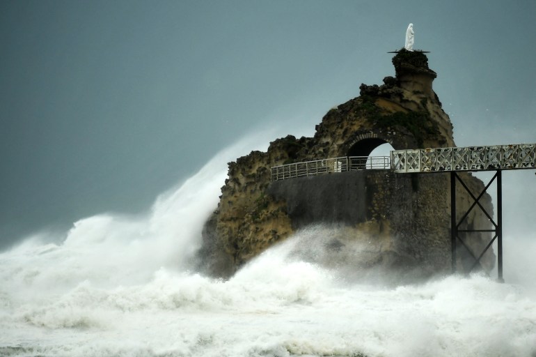 Huge waves crash on Rocher de La Vierge (Virgin Rock) near Biarritz on the west coast of France.  There is a statue on top of the rock.  And wild seas all around. 