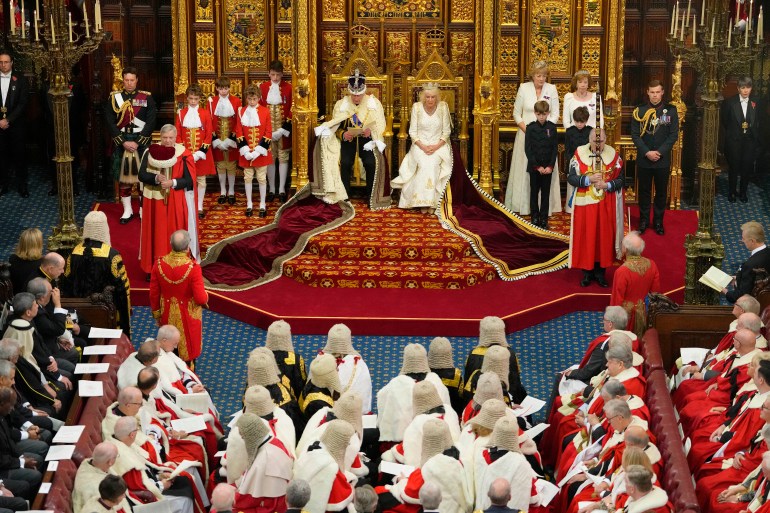 Britain's King Charles III, wearing the Imperial State Crown and the Robe of State, and Britain's Queen Camilla, wearing the George IV State Diadem, sits on The Sovereign's Throne in the House of Lords chamber, during the State Opening of Parliament, at the Houses of Parliament, in London, on November 7, 2023. (Photo by Kirsty Wigglesworth / POOL / AFP)