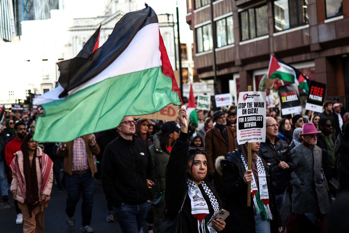 Protesters holding placards and Palestinian flags take part in the 'National March For Palestine' in central London
