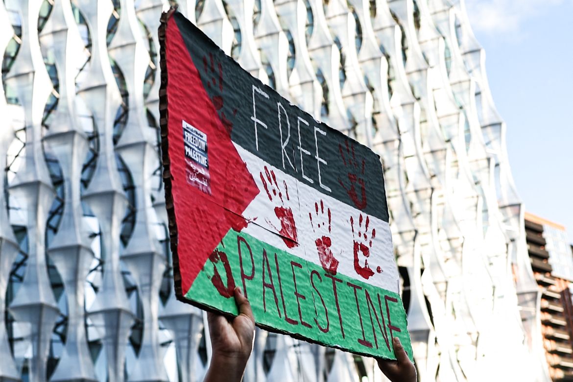 A protestor holds a placard while taking part in the 'National March For Palestine' in central London calling for a ceasefire in the conflict between Israel and Hamas.