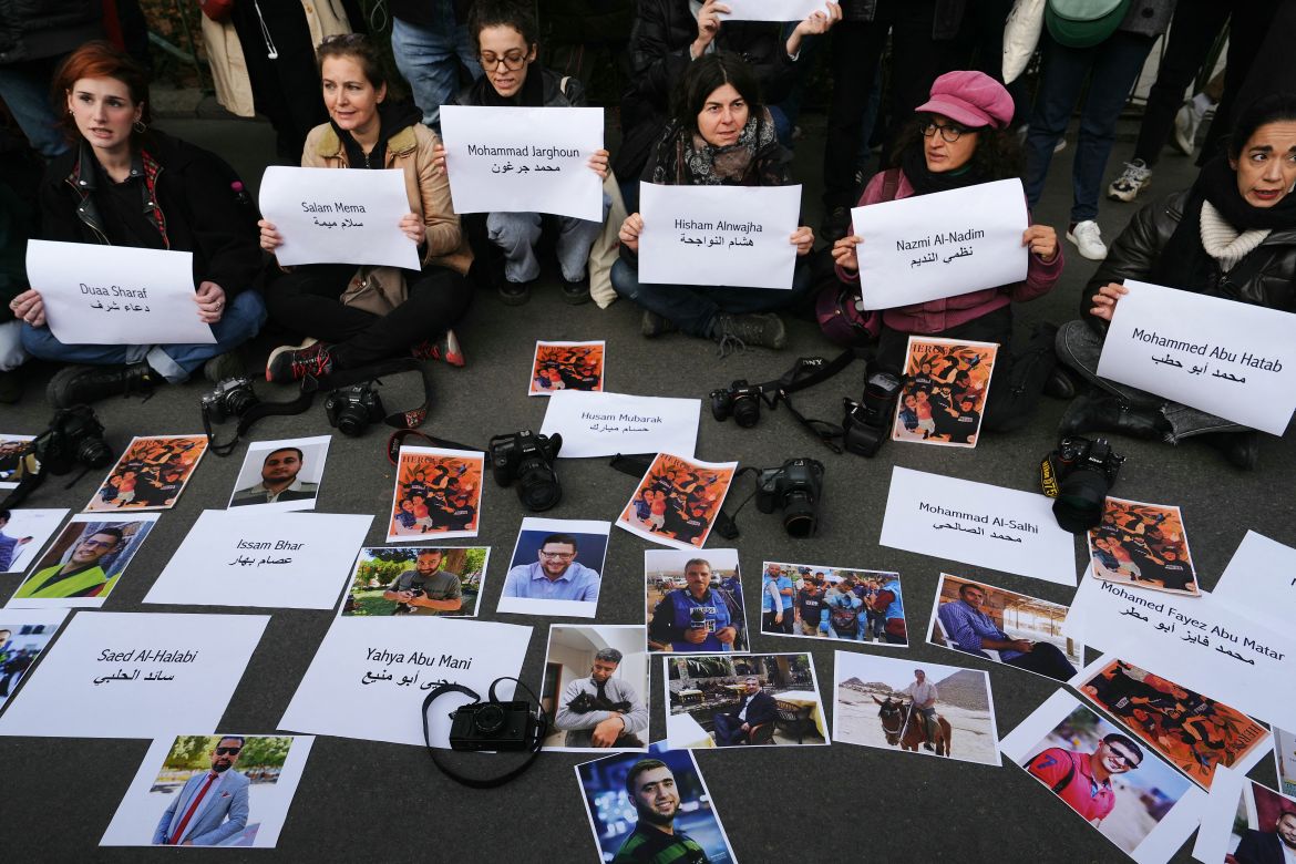 Protesters display the names and photographs of journalists who have been killed in Gaza since October 7, as they take part in a demonstration to demand an immediate ceasefire in Gaza near Place de la Republique in Paris.