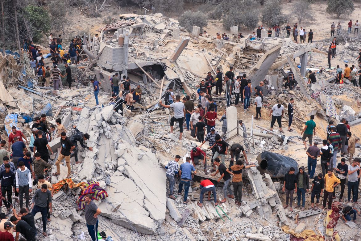 Civilians and rescuers look for survivors amid the rubble of a destroyed building following an Israeli bombardment in Khan Yunis in the southern Gaza Strip.