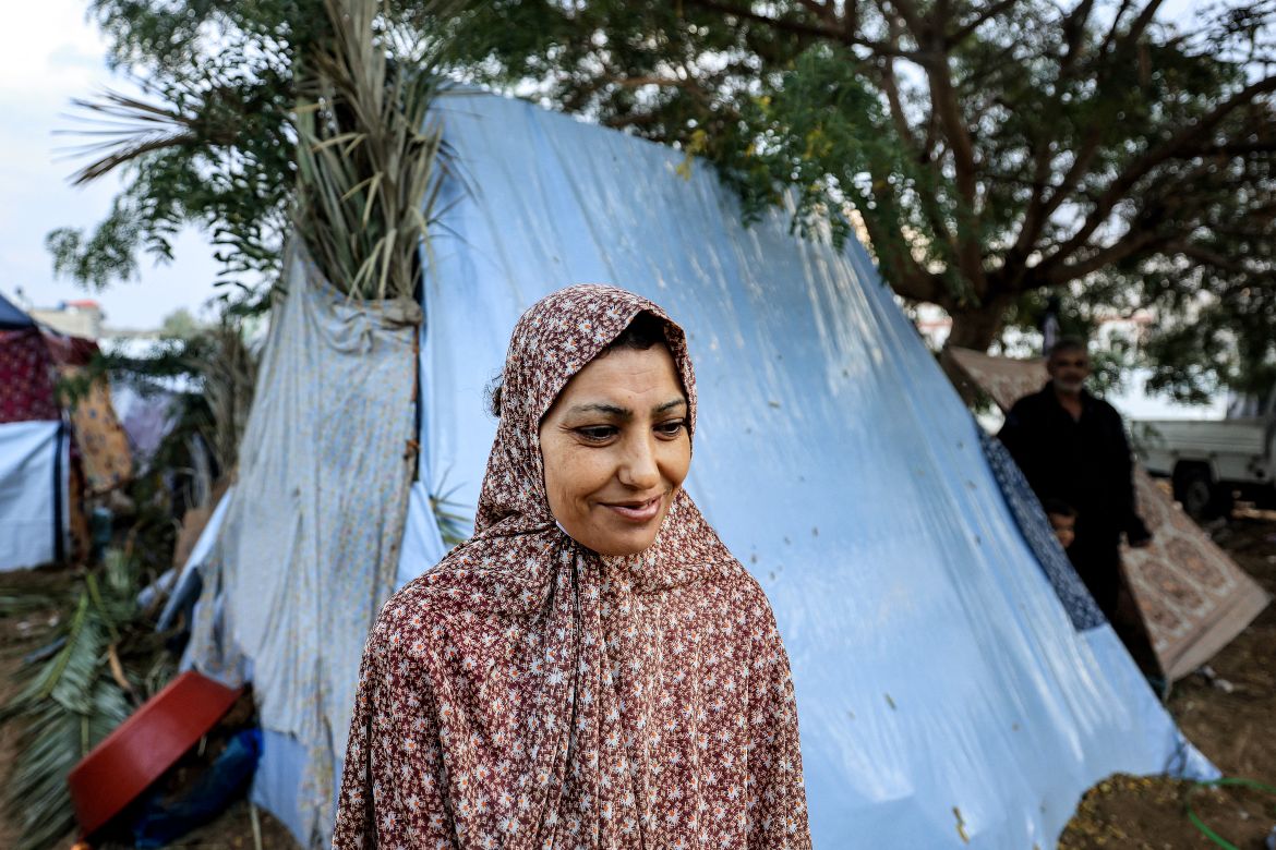 A woman stands outside one of the tents pitched by Palestinians taking shelter from Israeli bombardment around Nasser Hospital, in Khan Yunis in the southern Gaza Strip on November 14