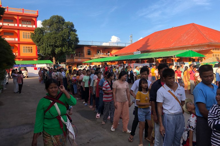 People queueing for food at a monastery providing temporary shelter to people displaced by fighting