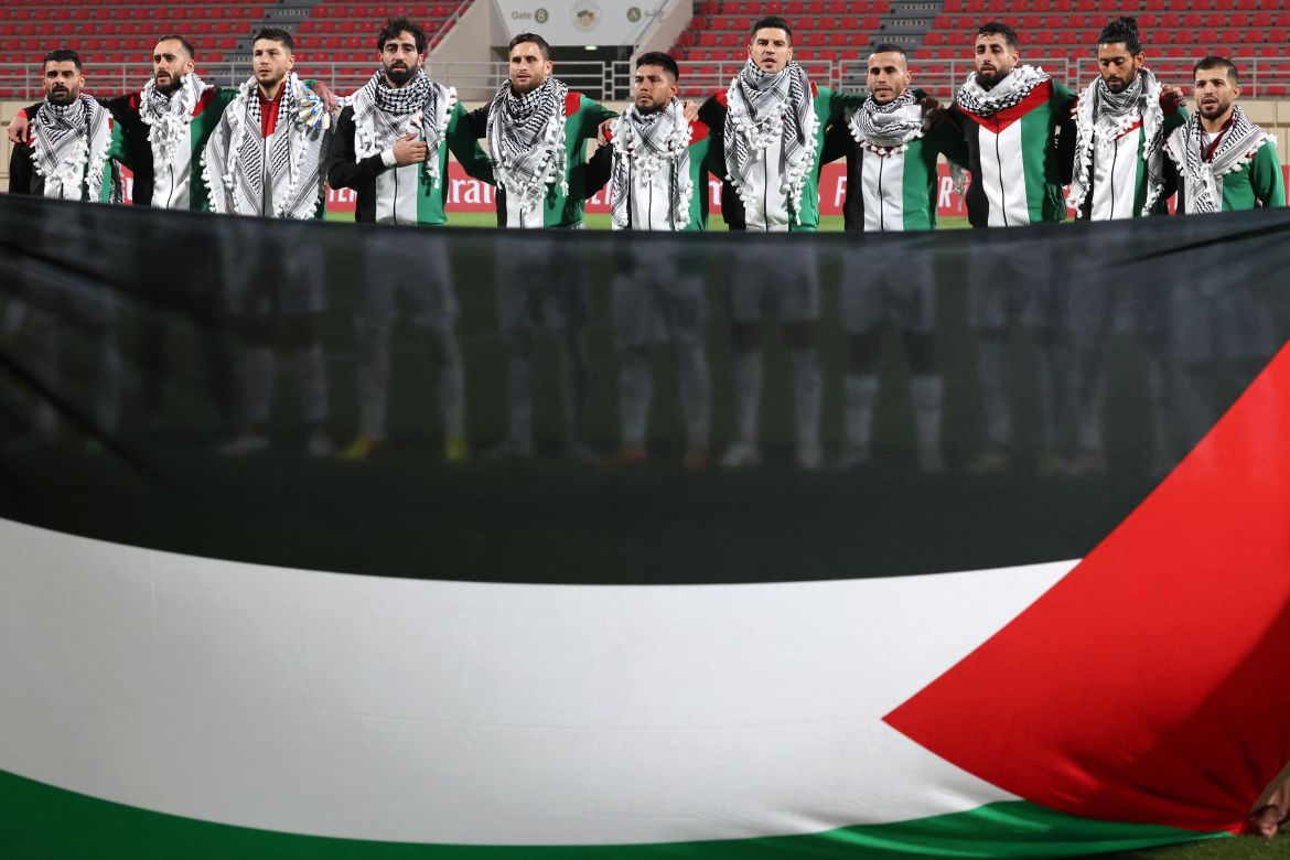 Palestine's starting eleven gather for their national anthem ahead of the 2026 FIFA World Cup AFC qualifiers football match between Lebanon and Palestine at the Khalid Bin Mohammed Stadium in Sharjah.
