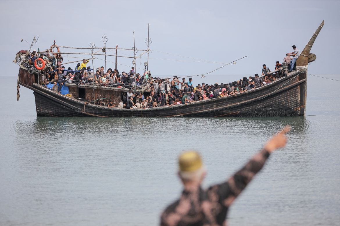 Newly arrived Rohingya refugees are stranded on a boat after the nearby community decided not to allow them to land after giving them water and food in Pineung, Aceh province.