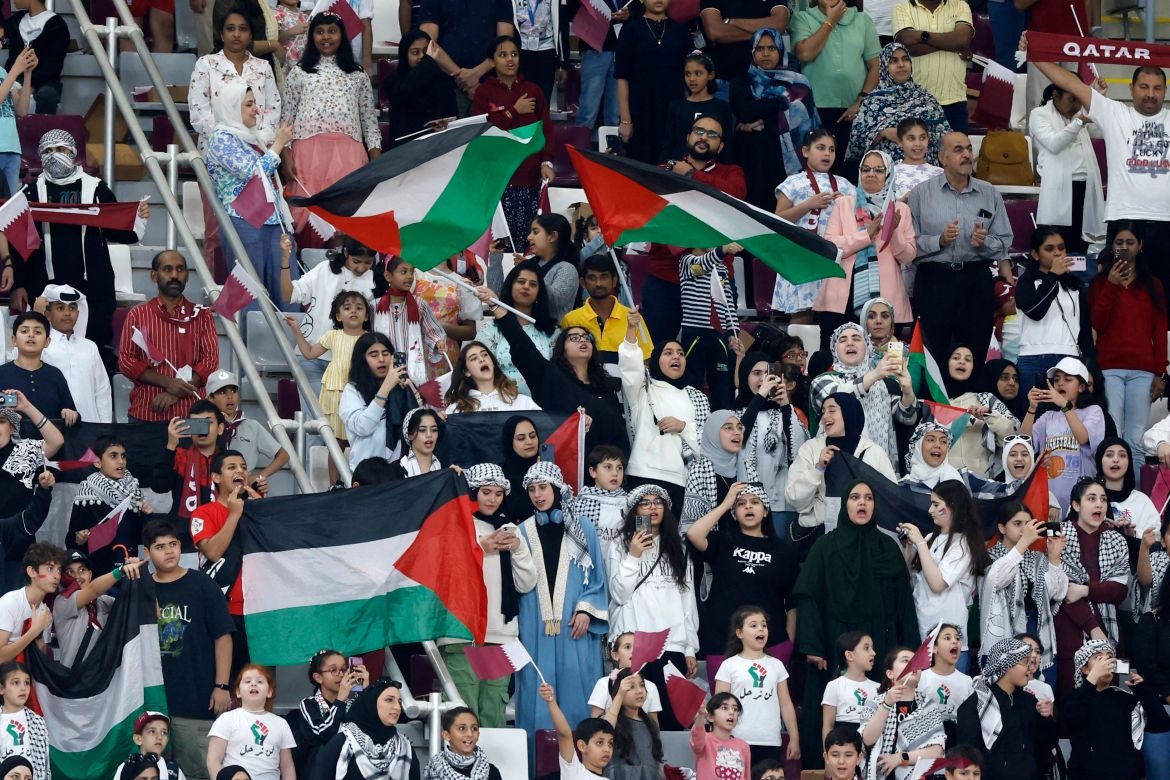 Fans wave the Palestinian flag during the 2026 FIFA World Cup AFC qualifiers football match between Qatar and Afghanistan at the Khalifa International Stadium.