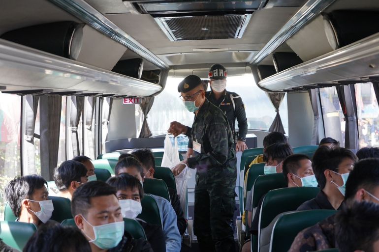This handout photo taken and released on November 18, 2023 by the Royal Thai Army shows Thai military personnel with some of the 41 Thai nationals on a bus to Mae Sai after they returned to Thailand after being trapped in Myanmar. - Forty-one Thais trapped in Myanmar for three weeks by an upsurge in fighting between the junta and an alliance of ethnic minority armed groups returned to the kingdom on November 18, the Thai army said. (Photo by Handout / ROYAL THAI ARMY / AFP) / -----EDITORS NOTE --- RESTRICTED TO EDITORIAL USE - MANDATORY CREDIT "AFP PHOTO / ROYAL THAI ARMY " - NO MARKETING - NO ADVERTISING CAMPAIGNS - DISTRIBUTED AS A SERVICE TO CLIENTS - - -----EDITORS NOTE --- RESTRICTED TO EDITORIAL USE - MANDATORY CREDIT "AFP PHOTO / ROYAL THAI ARMY " - NO MARKETING - NO ADVERTISING CAMPAIGNS - DISTRIBUTED AS A SERVICE TO CLIENTS - /