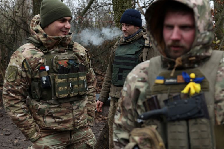 Ukrainian soldiers smoking cigarettes during a break