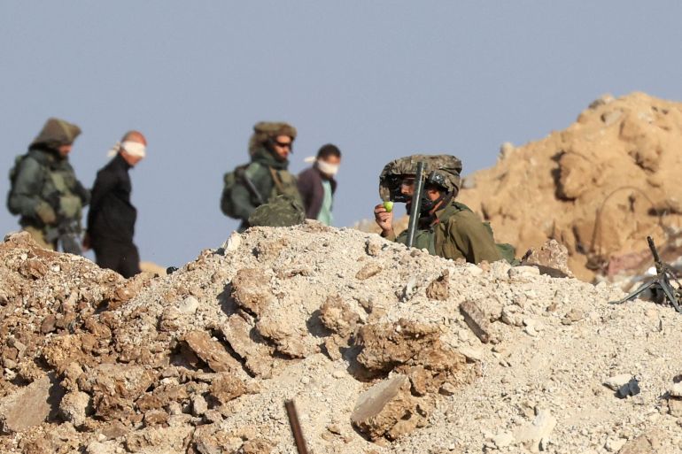 Israeli soldiers detain blindfolded Palestinian men