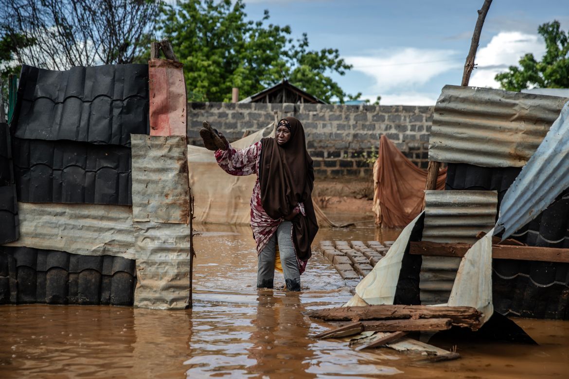 Fatuma Hassan, 42, tries to collect some of her belongings at the inundated area where she lives following flash floods in Garissa.