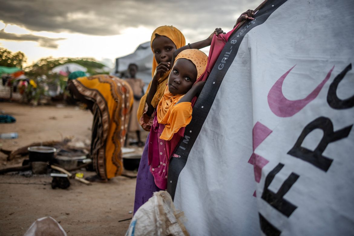 A girl looks on in front of the shelter where she lives with her family at an internally displaced persons (IDP) camp for families displaced by floods in Garissa.