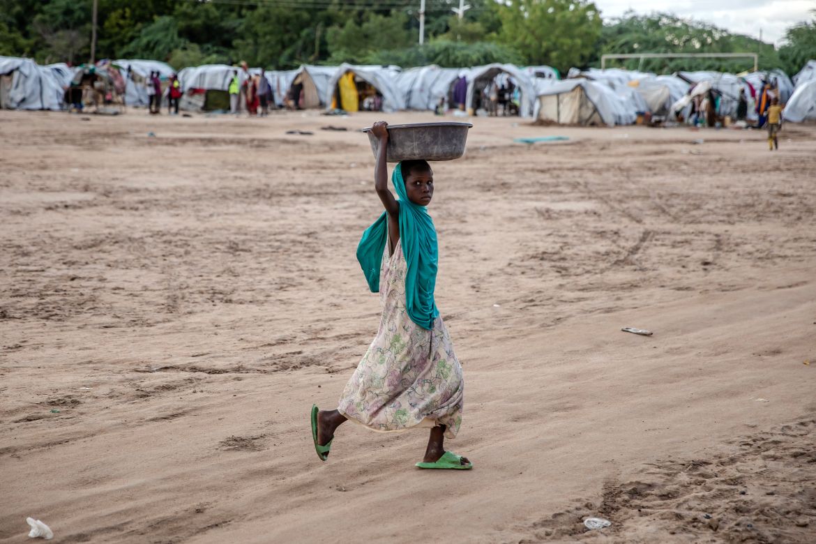A girl carries goods at an internally displaced persons (IDP) camp for families displaced by floods in Garissa.