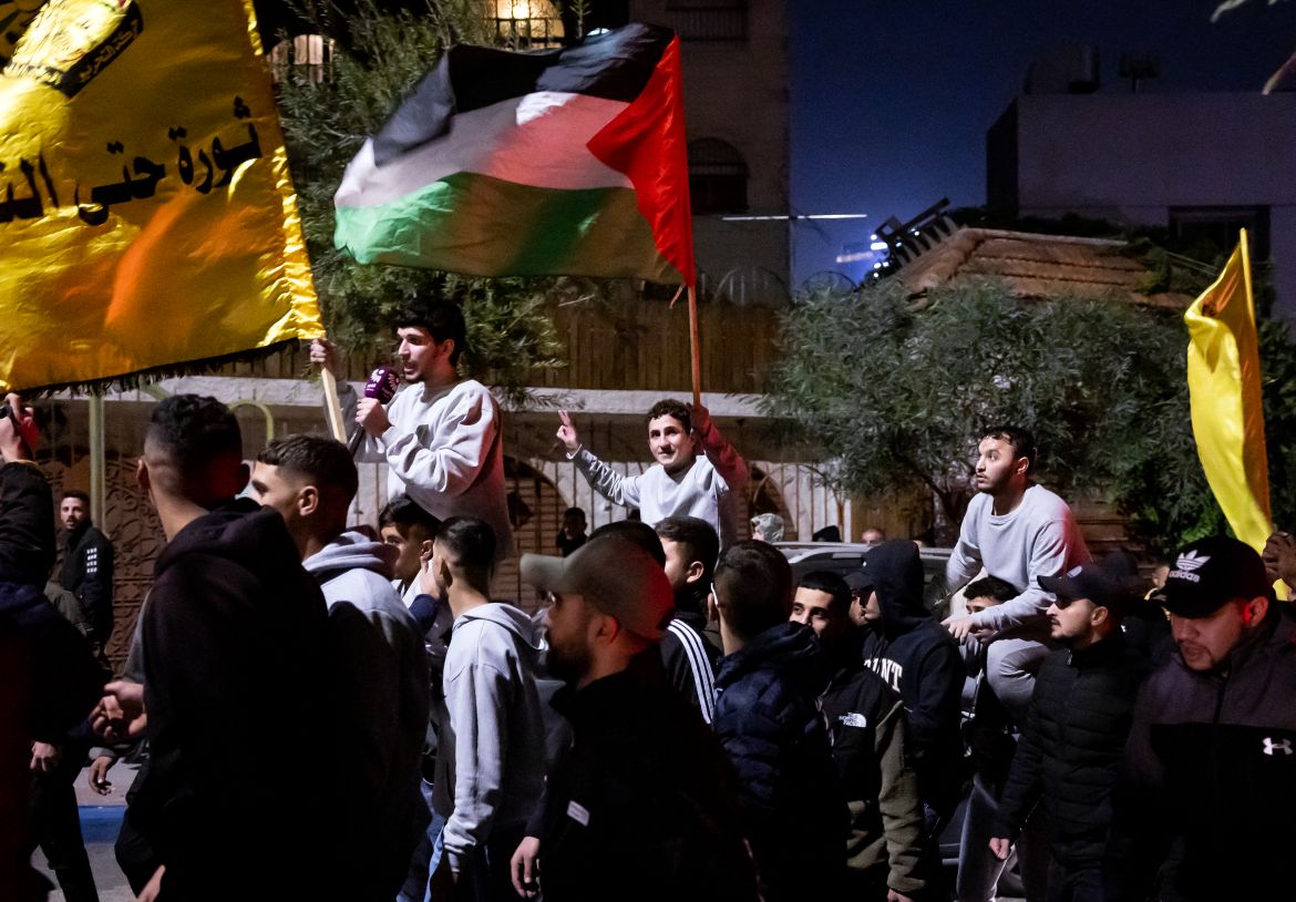 Palestinian prisoners (wearing grey jumpers) cheer among supporters and relatives after being released from Israeli jails in exchange for Israeli hostages released by Hamas from the Gaza Strip, in Ramallah in the occupied West Bank.